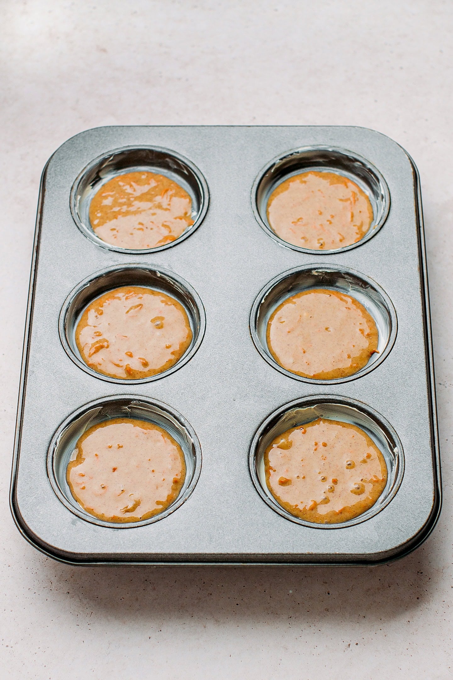 Muffin pan filled with batter.
