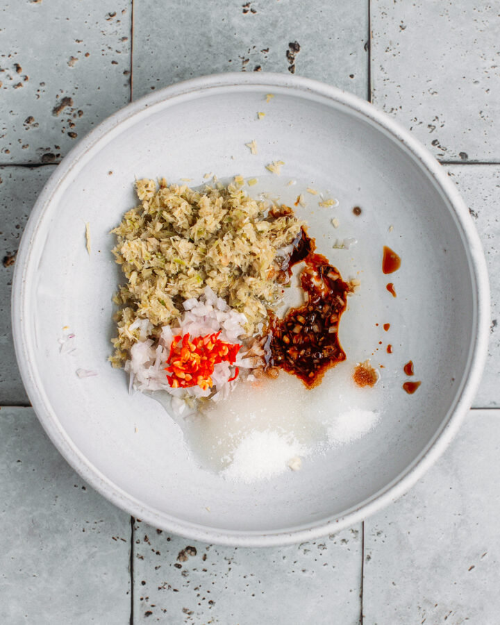 Minced lemongrass, salt, sugar, shallot, and soy sauce in a bowl.