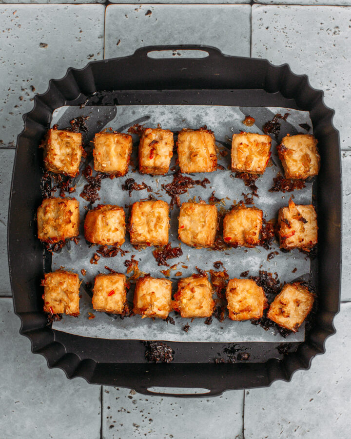 Air fried lemongrass tofu in an air fryer basket.