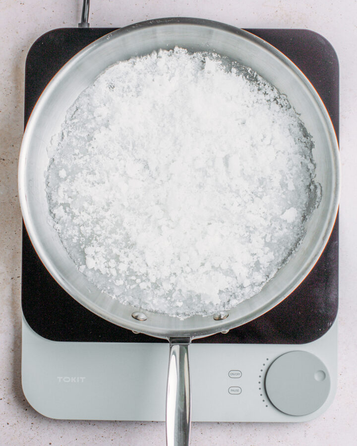 Sugar melting in a large pan.