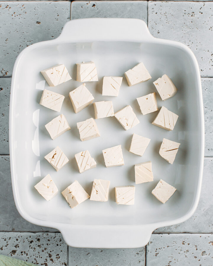 Diced tofu in a baking dish.