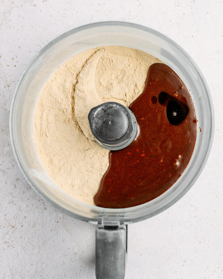 Protein powder, coconut nectar, and almond butter in a food processor.