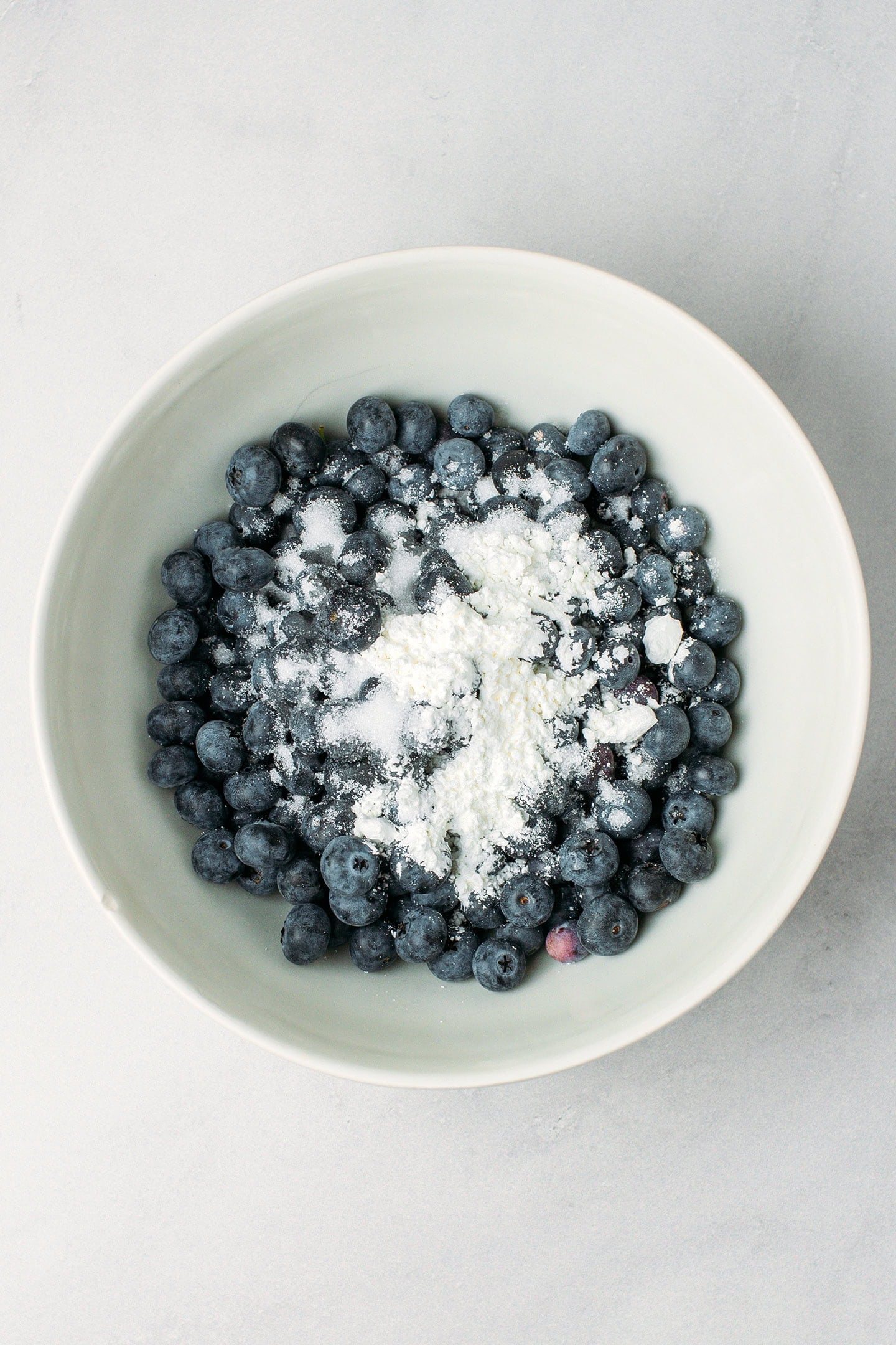 Blueberries and cornstarch in a mixing bowl.