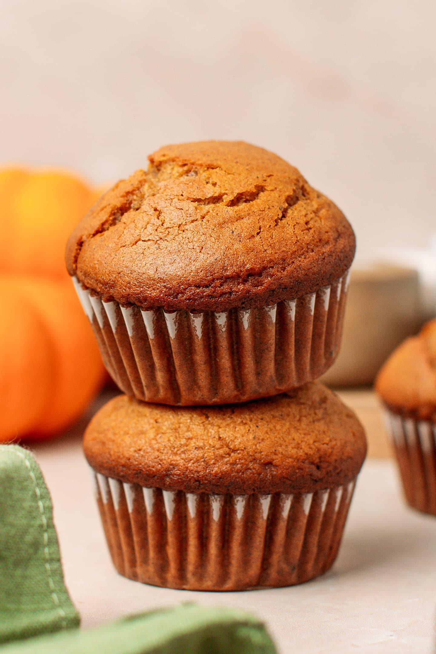 Two pumpkin muffins stacked.