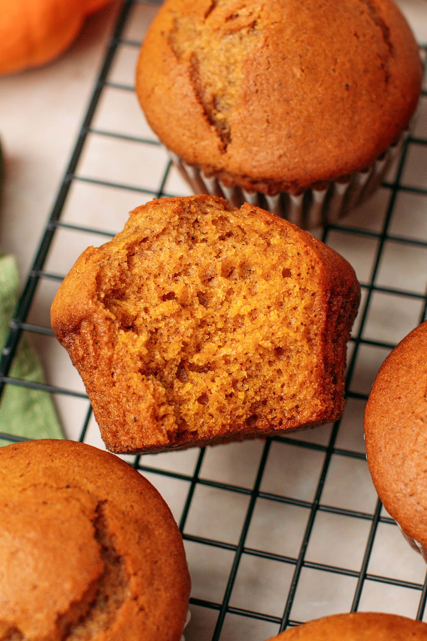 Close-up of a pumpkin muffin with a bite.