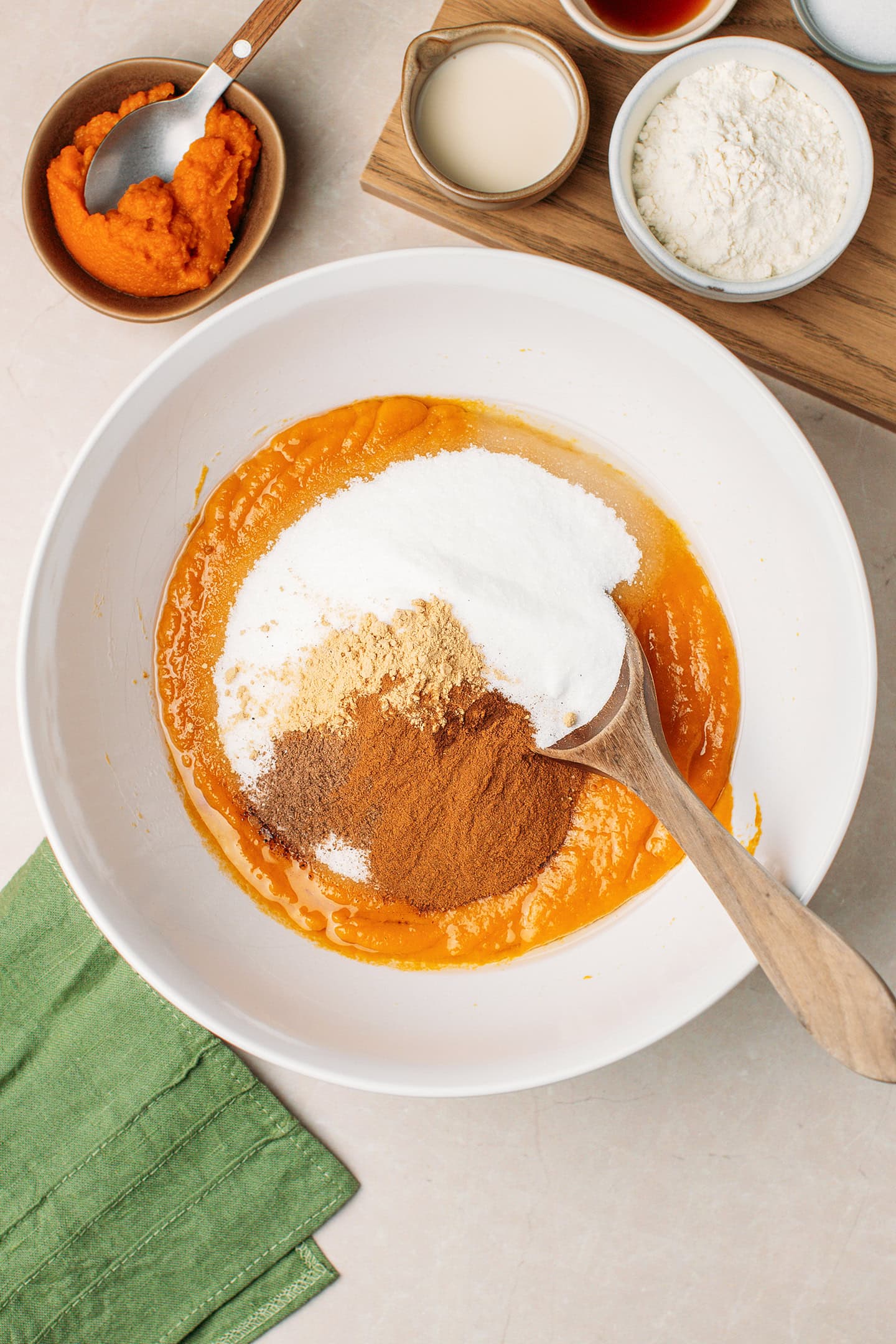 Pumpkin purée, sugar, and spices in a mixing bowl.